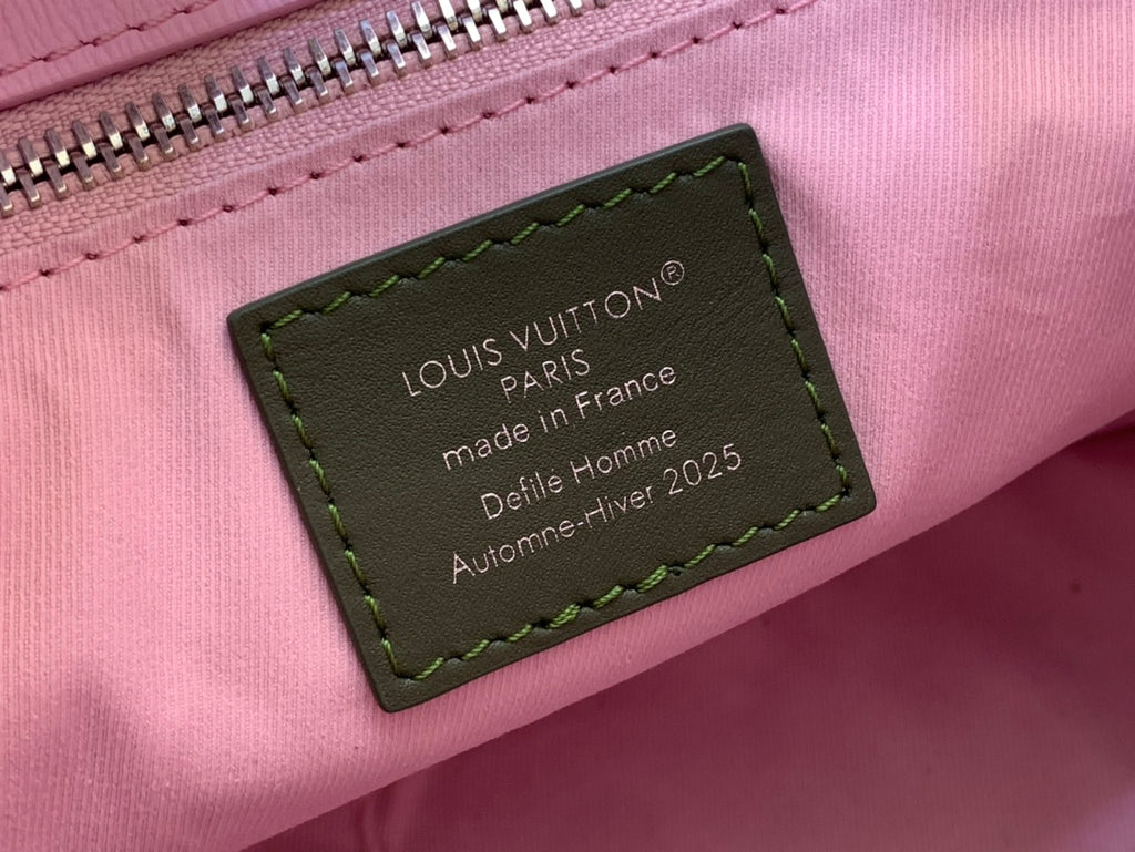Louis Vuitton authenticity label on pink leather bag with green-stitched border
