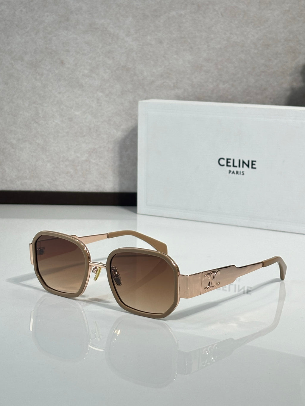 Tortoise sunglasses with brown lenses, gold-tone frame accents, round-square shape