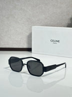 Black sunglasses with dark lenses and thick round frames, gold-tone hinges
