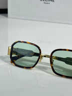 Tortoise sunglasses with gold-tone rim and green-tinted lenses, square style