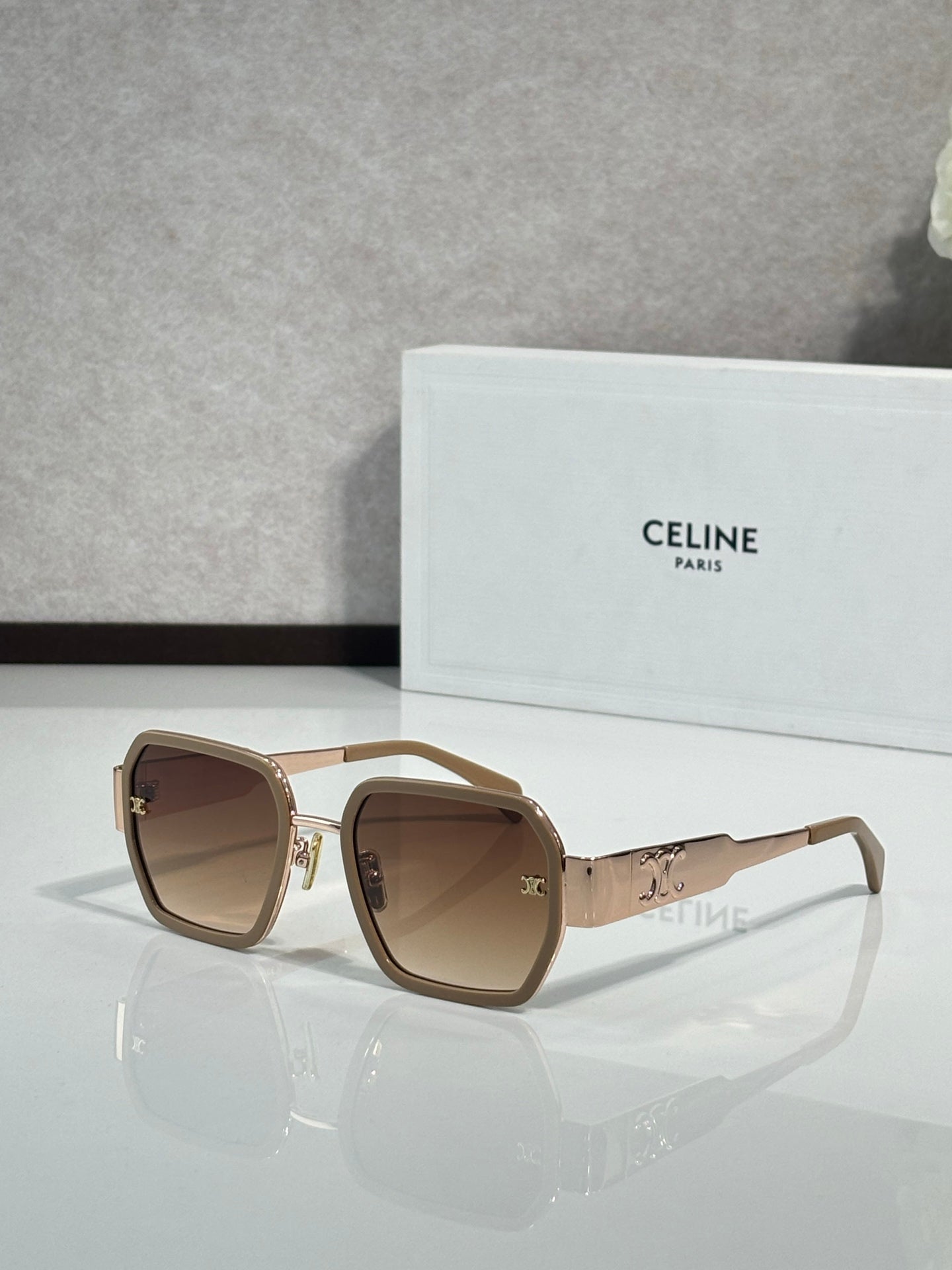 Square beige sunglasses with brown lenses and gold logo on the temple arms