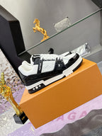 Louis Vuitton ladies sneakers on orange box, side view with black and white panels.