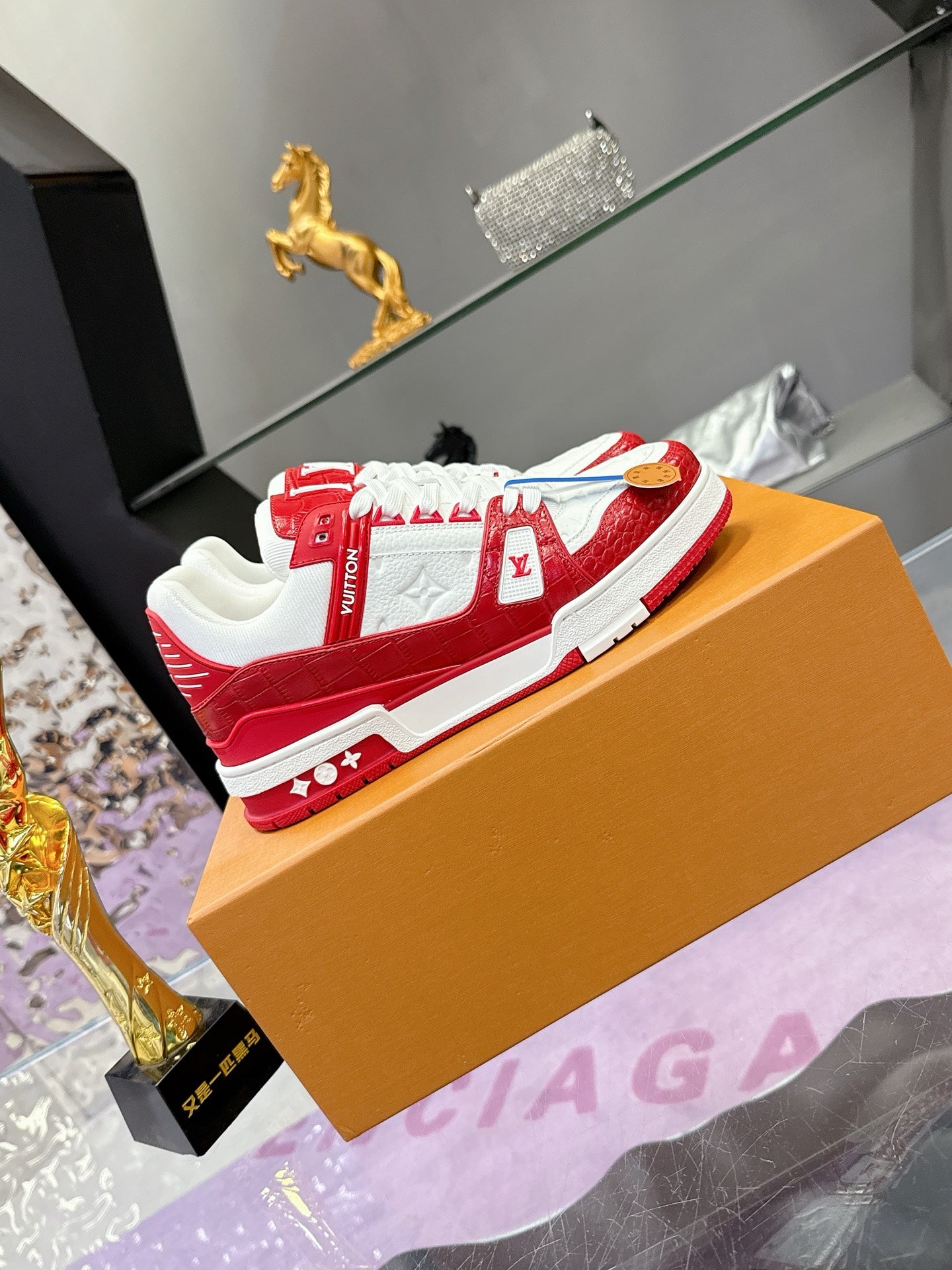Louis Vuitton red-and-white low-top sneakers with LV logos and white lace-up front