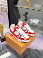 Louis Vuitton red-and-white low-top sneakers on a tan box with white rubber sole