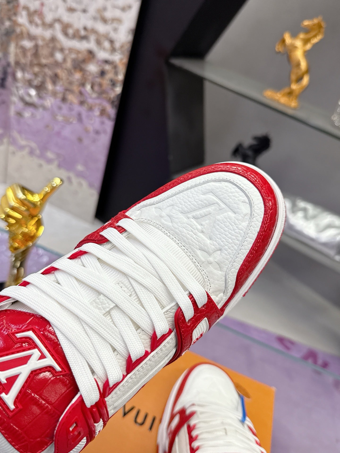 Louis Vuitton red-and-white sneaker toe and laces with embossed logo on the white panel