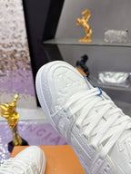 Louis Vuitton women's white lace sneakers, close-up embroidered logo on tongue