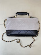 Chanel handbag with light gray top flap and dark navy quilted front, gold chain strap