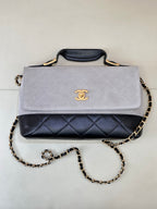 Chanel shoulder bag with light gray flap, navy quilted front band, gold chain strap