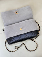 Chanel flap bag in light gray with dark navy quilted lower band, gold-tone chain strap