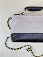 Chanel small crossbody bag with light gray suede-look flap and dark navy quilted section