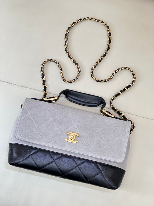 Chanel crossbody bag with light gray flap, dark navy quilted panel, gold-tone chain strap