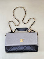 Chanel flap bag with light gray suede-look top and dark navy quilted bottom, chain strap