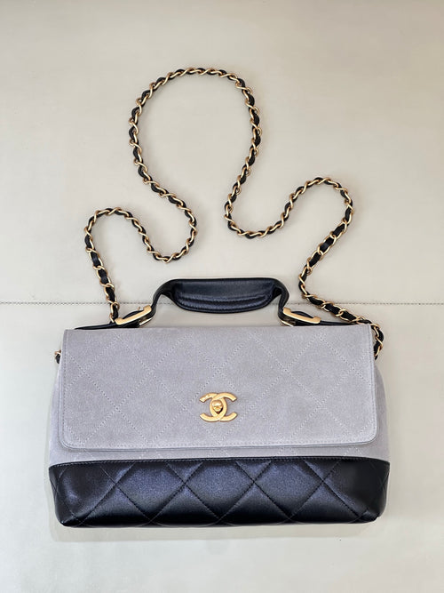 Chanel flap bag with light gray suede-look top and dark navy quilted bottom, chain strap