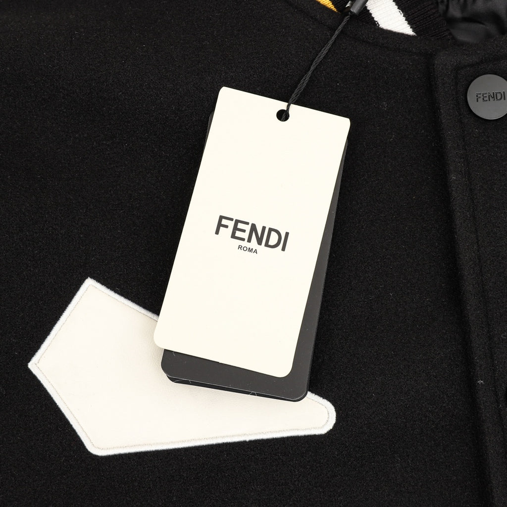 Black varsity jacket with hanging FENDI care tag and snap-front placket