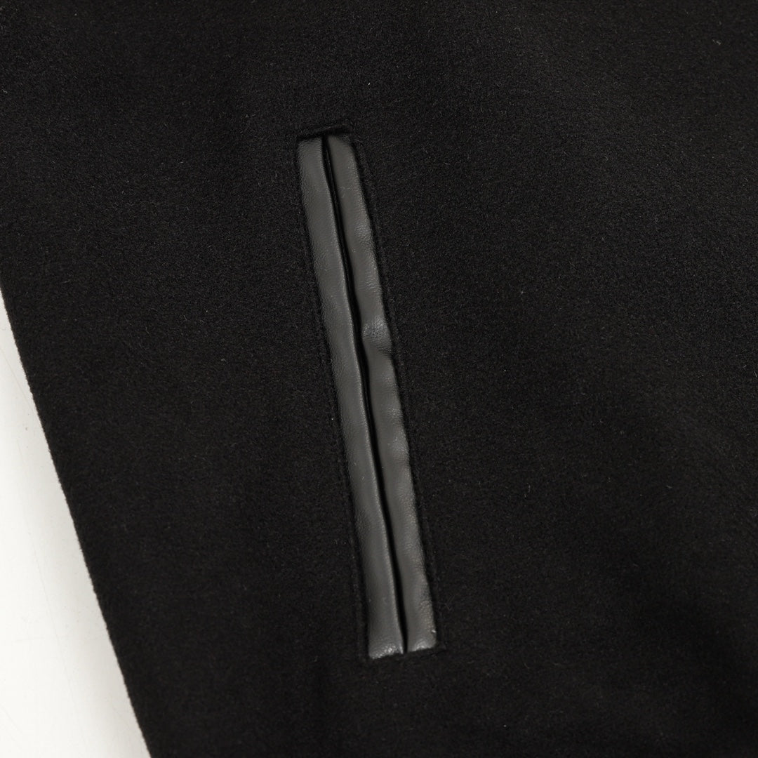 Black varsity jacket with vertical side pocket seam detail