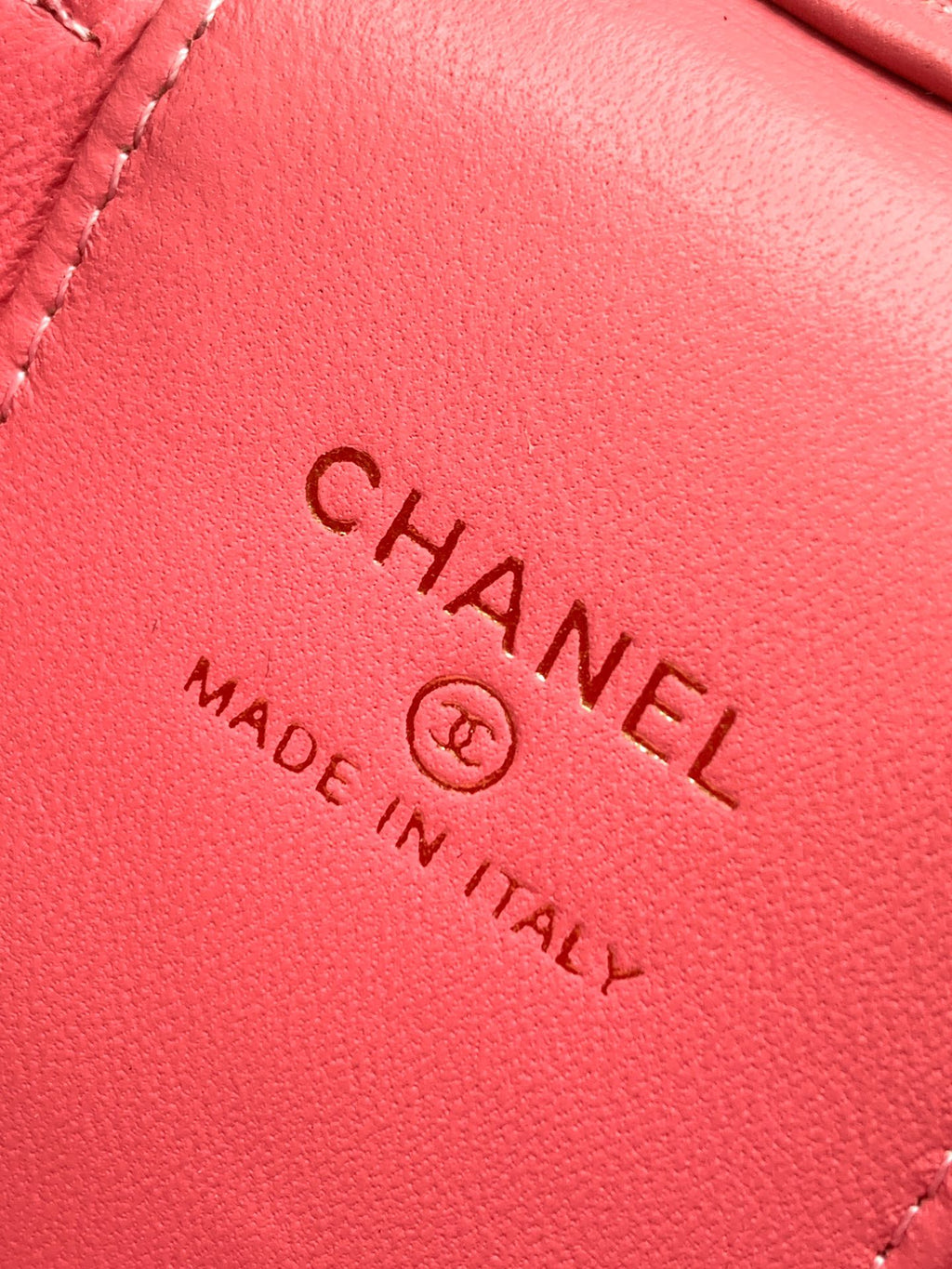 Pink leather bag close-up showing 'Chanel' and 'Made in Italy' stamp