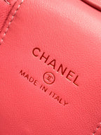 Pink leather bag close-up showing 'Chanel' and 'Made in Italy' stamp