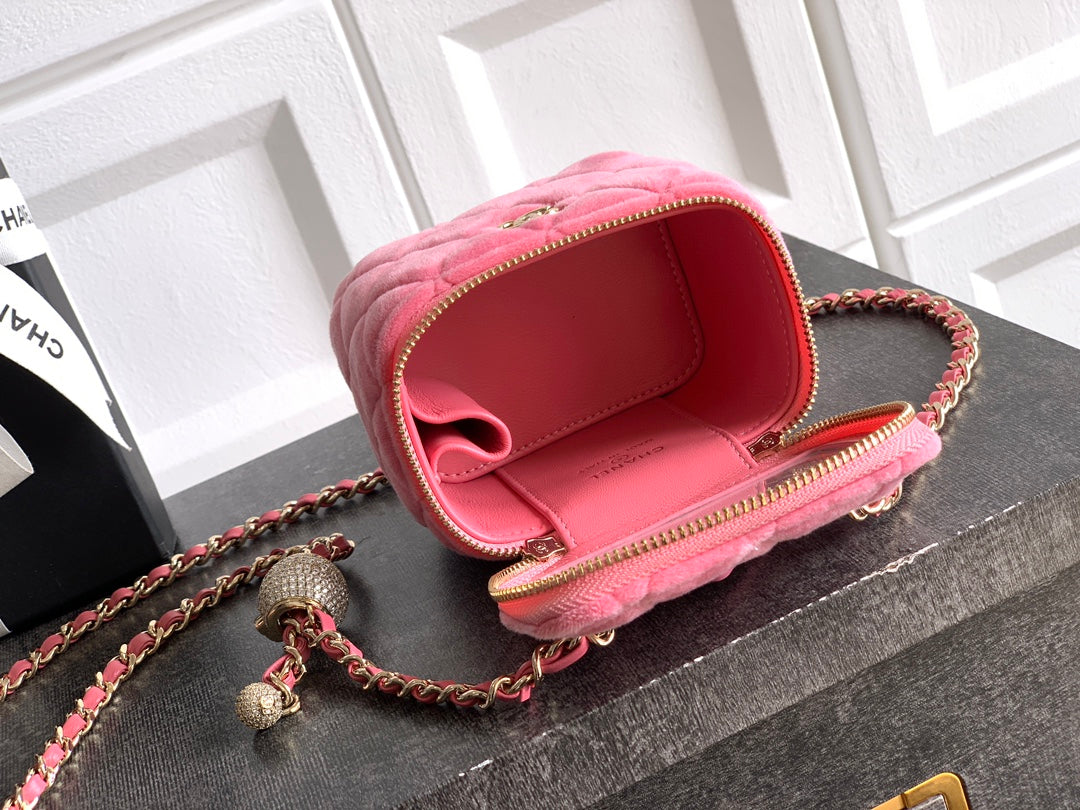 Pink mini bag open view with red lining and gold-tone zipper on chain strap
