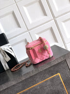 Pink quilted mini bag with gold-tone chain strap and top zipper closure
