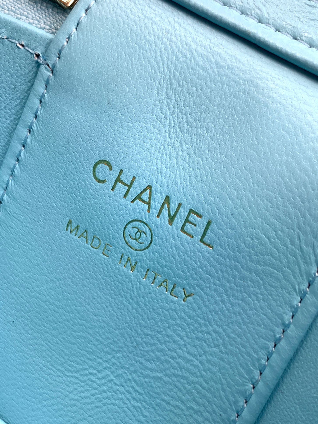 Chanel light blue leather mini bag label with CHANEL and Made in Italy text