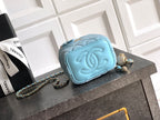 Chanel light blue quilted mini bag with embossed CC flap, chain strap, and zipper