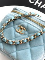Chanel light blue quilted bag close-up showing gold zipper and chain strap