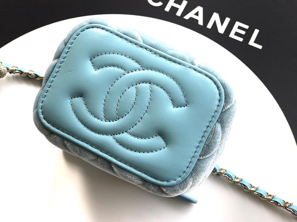 Chanel light blue quilted mini bag close-up showing embossed CC logo on front