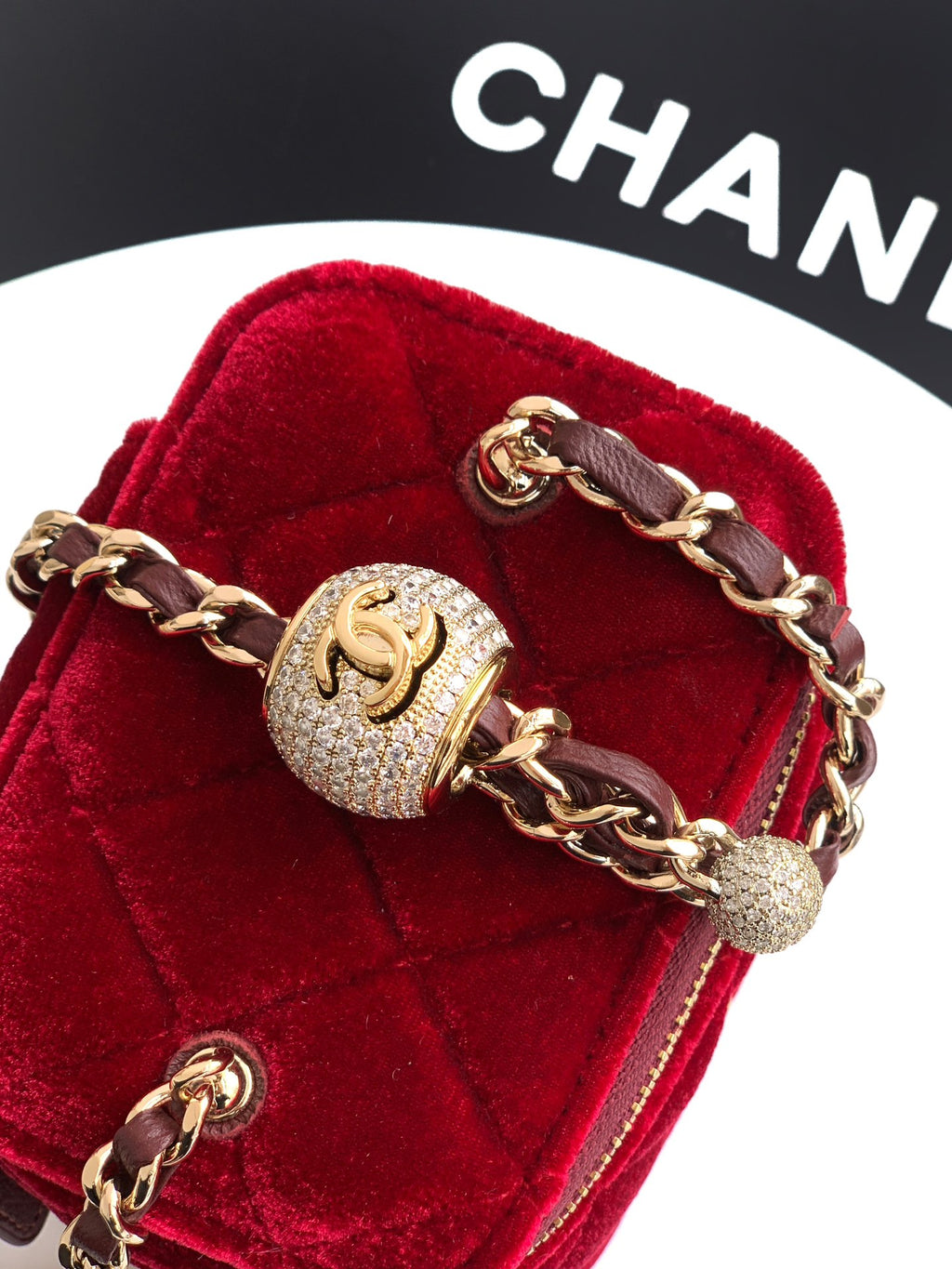 Red velvet Chanel mini bag close-up with gold hardware, chain, and CC logo