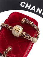 Red velvet Chanel mini bag close-up with gold hardware, chain, and CC logo