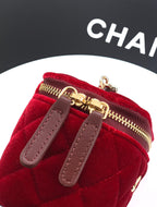 Red velvet Chanel mini bag close-up of front strap tabs and gold zipper