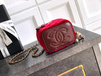 Red velvet Chanel mini bag with embossed CC emblem and gold chain strap