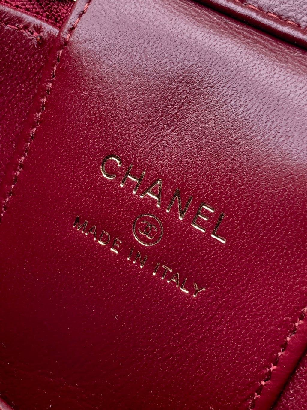 Red Chanel bag interior label with CHANEL and MADE IN ITALY text