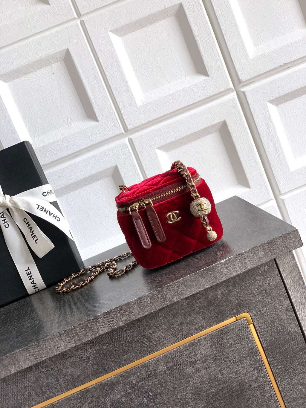 Red quilted mini Chanel bag with gold chain strap and top zip closure