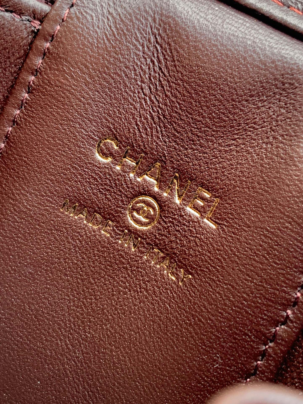 Brown leather bag exterior with stitched design and gold CC logo