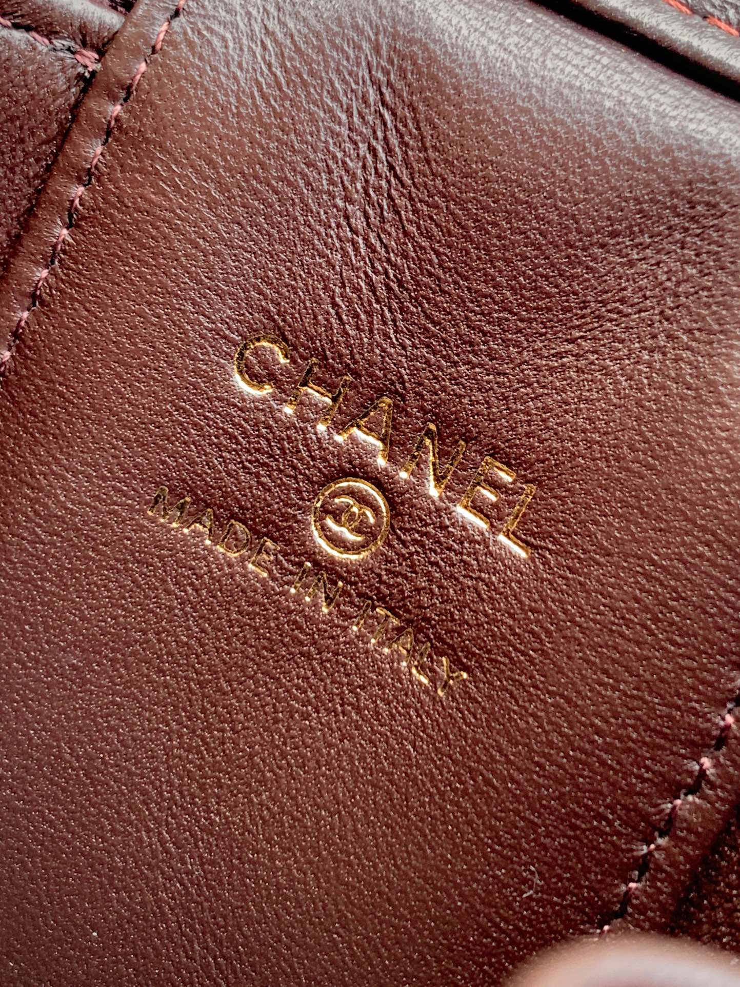 Brown leather bag exterior with stitched design and gold CC logo