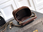 Brown mini crossbody bag open to show interior, with chain strap and zip trim