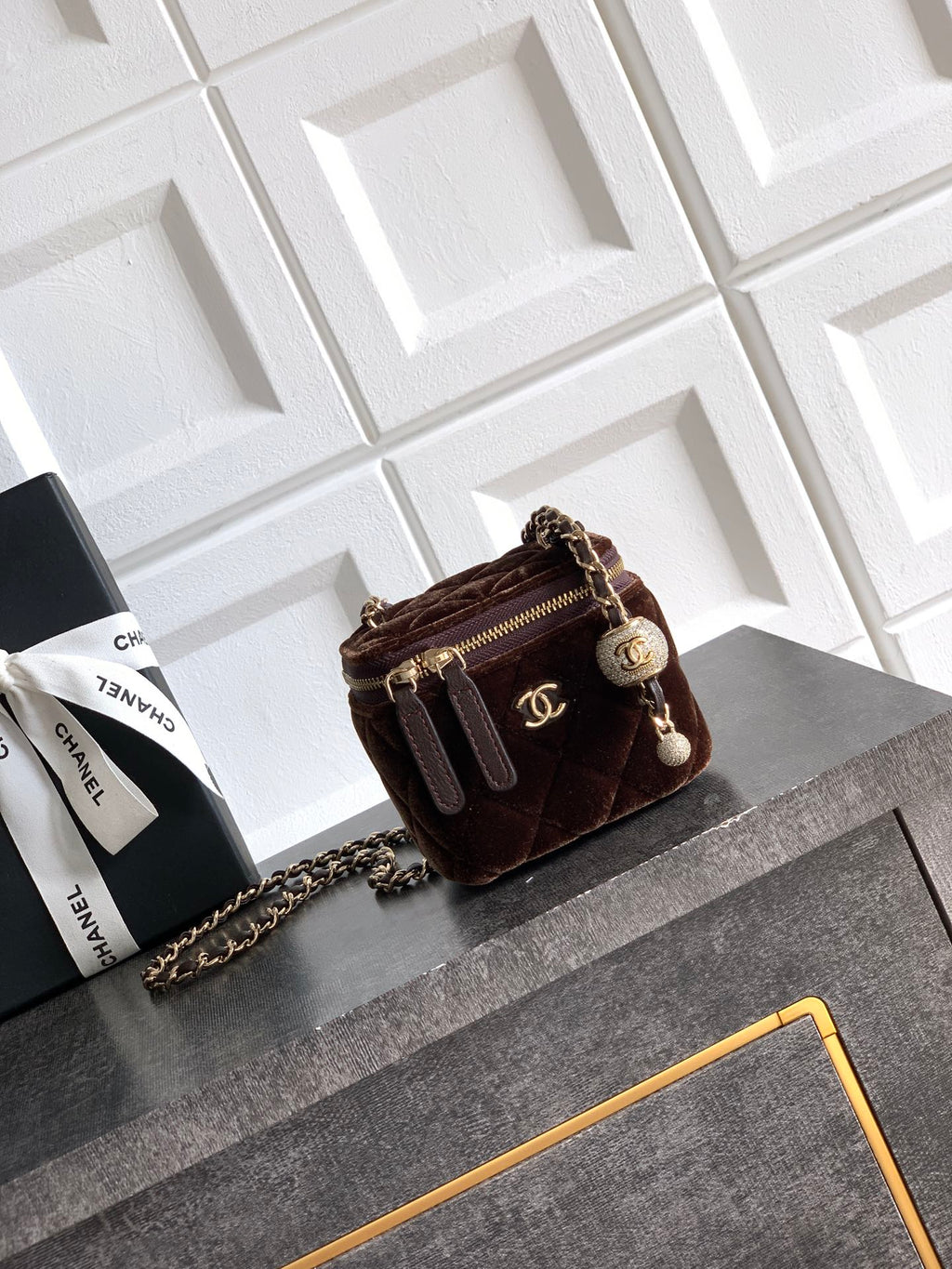 Quilted brown crossbody bag with chain strap, zip top and CC logo charm