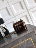Quilted brown crossbody bag with chain strap, zip top and CC logo charm