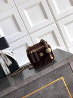 Quilted brown crossbody bag with chain strap, zip top and CC logo charm