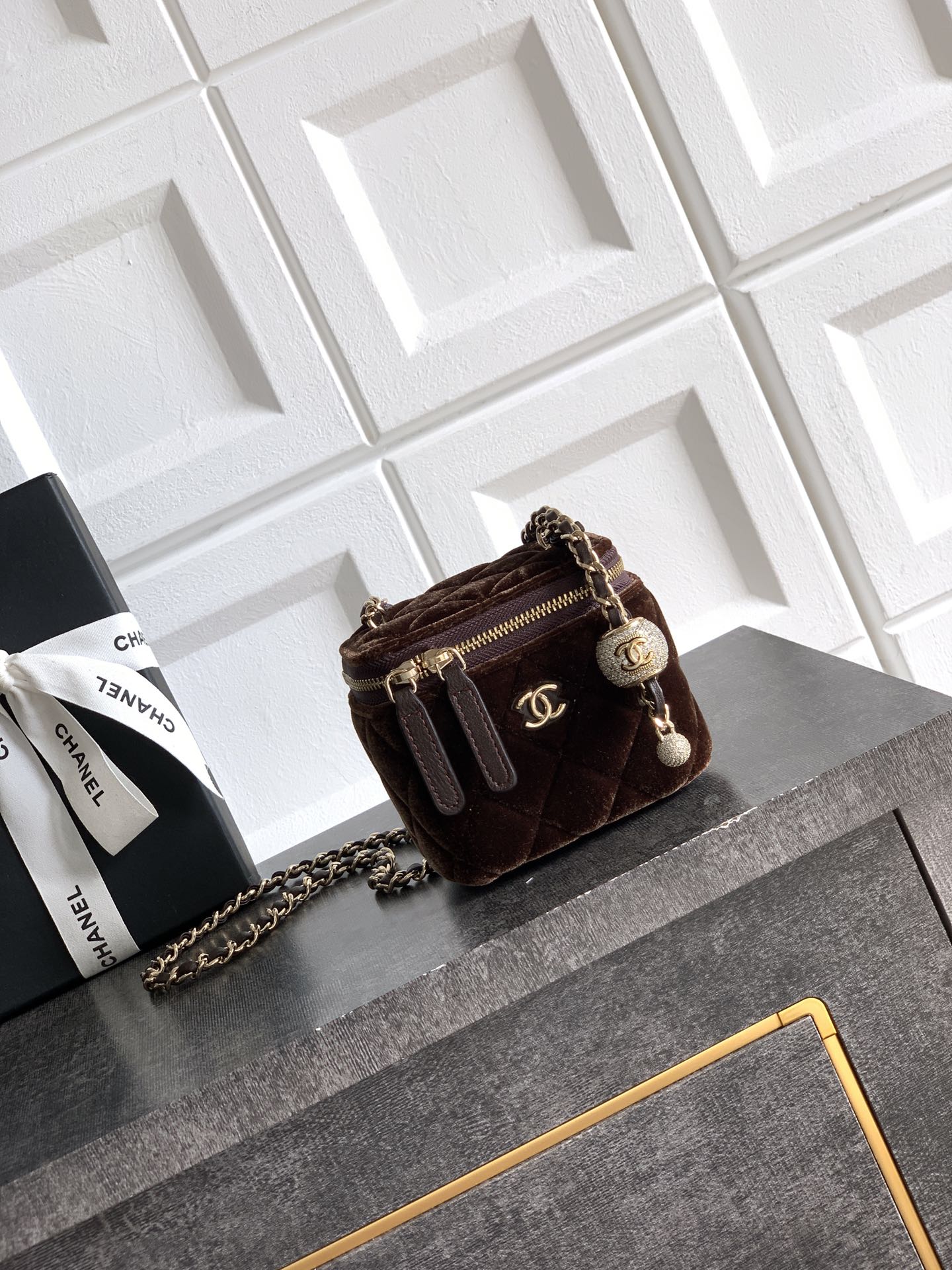 Quilted brown crossbody bag with chain strap, zip top and CC logo charm