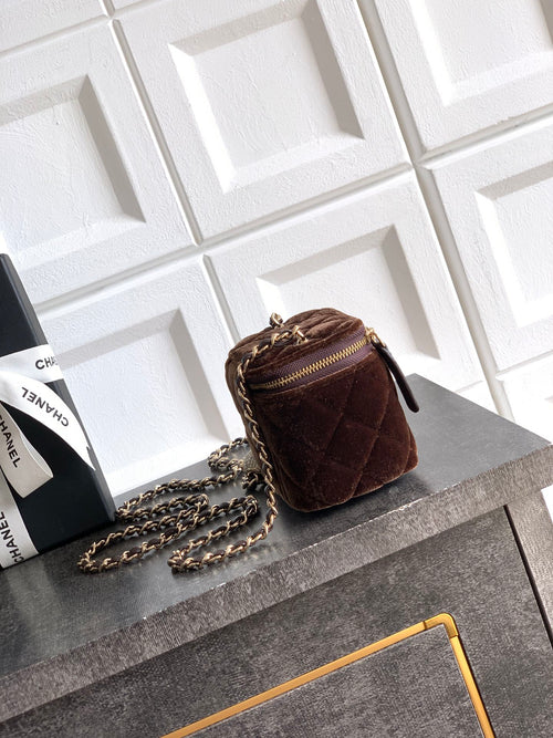 Quilted brown mini crossbody bag with gold-tone chain strap and zip closure