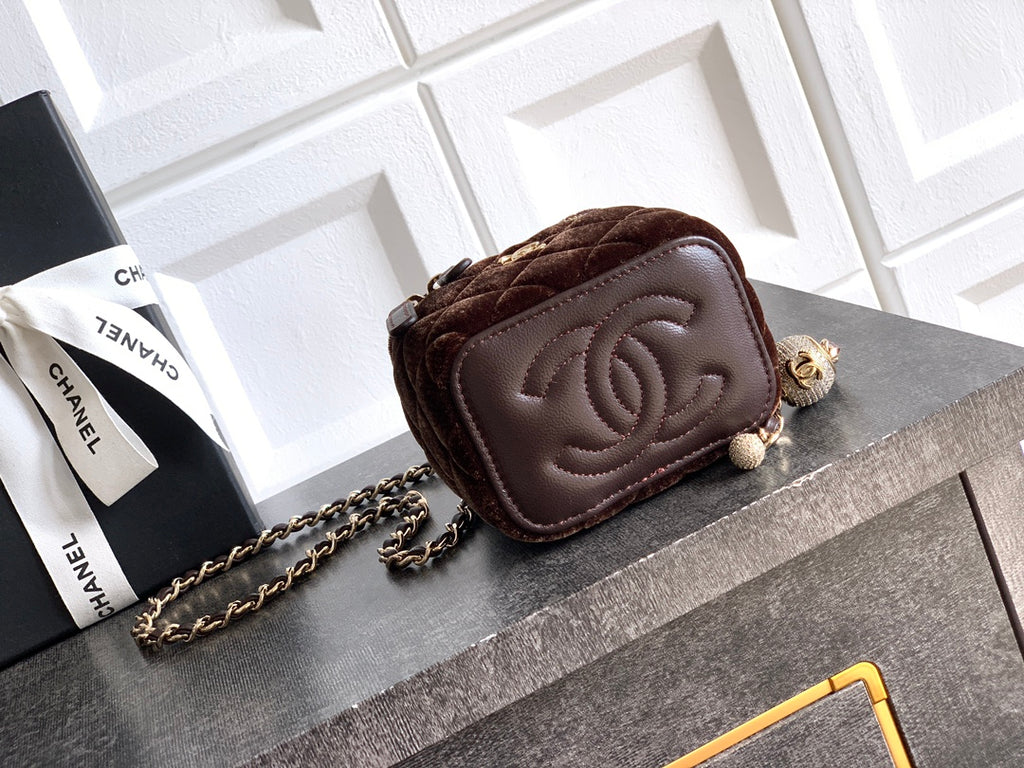Brown leather mini bag with embossed CC flap and chain strap, zip top