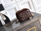 Brown leather mini bag with embossed CC flap and chain strap, zip top