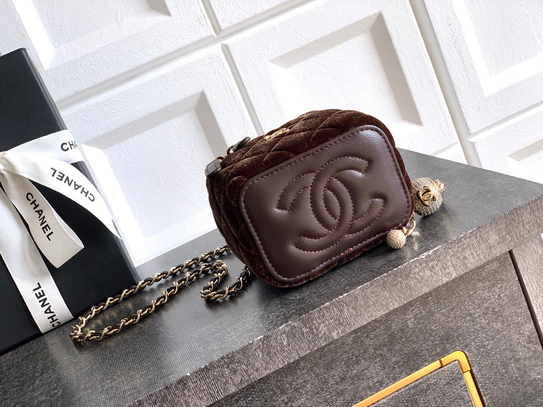 Brown leather mini bag with embossed CC flap and chain strap, zip top