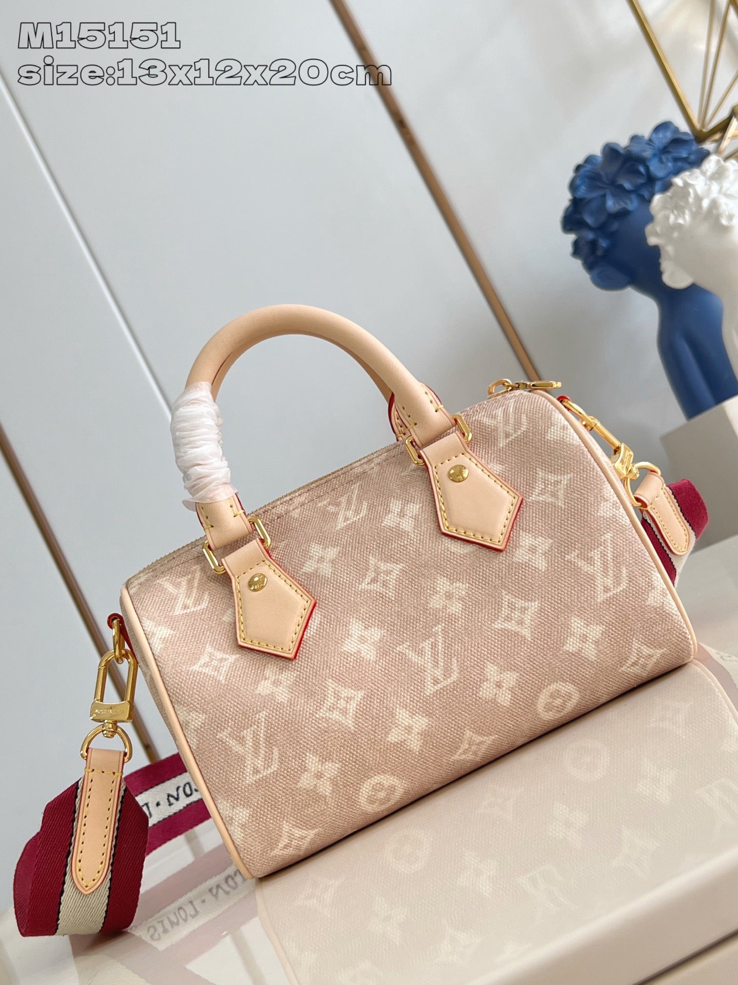 Louis Vuitton mini handbag in tan monogram canvas with key charm and red strap