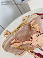 Mini monogram bag with top zipper pulls, cat charm, and red strap detail