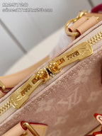 Mini monogram bag close-up of gold zipper track and zipper pull on tan canvas