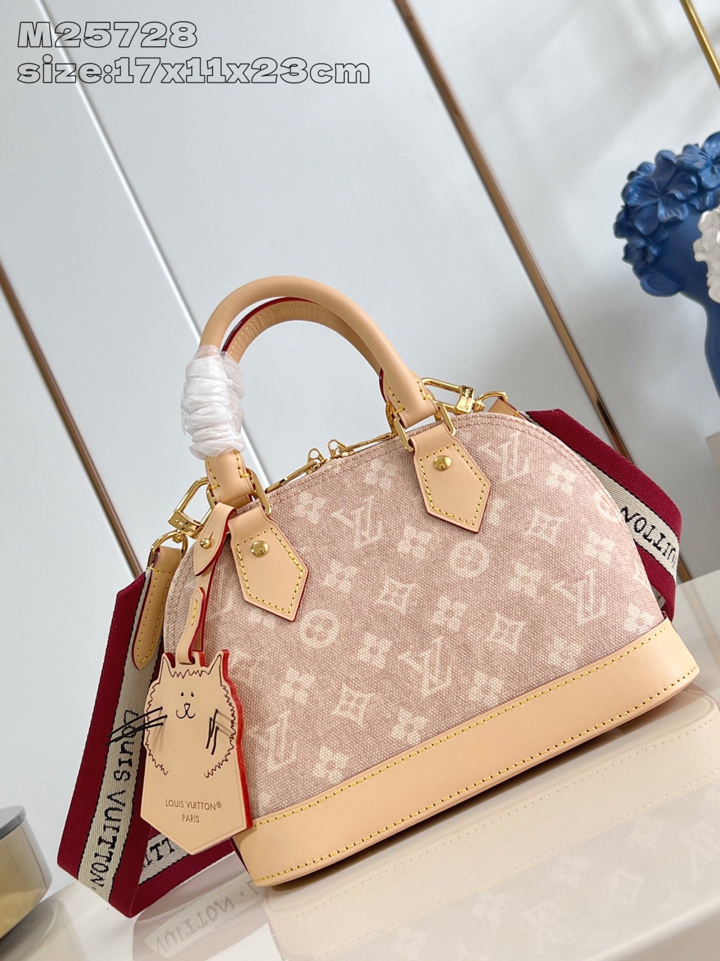 Louis Vuitton mini monogram bag with tan leather handles, red strap and gold hardware