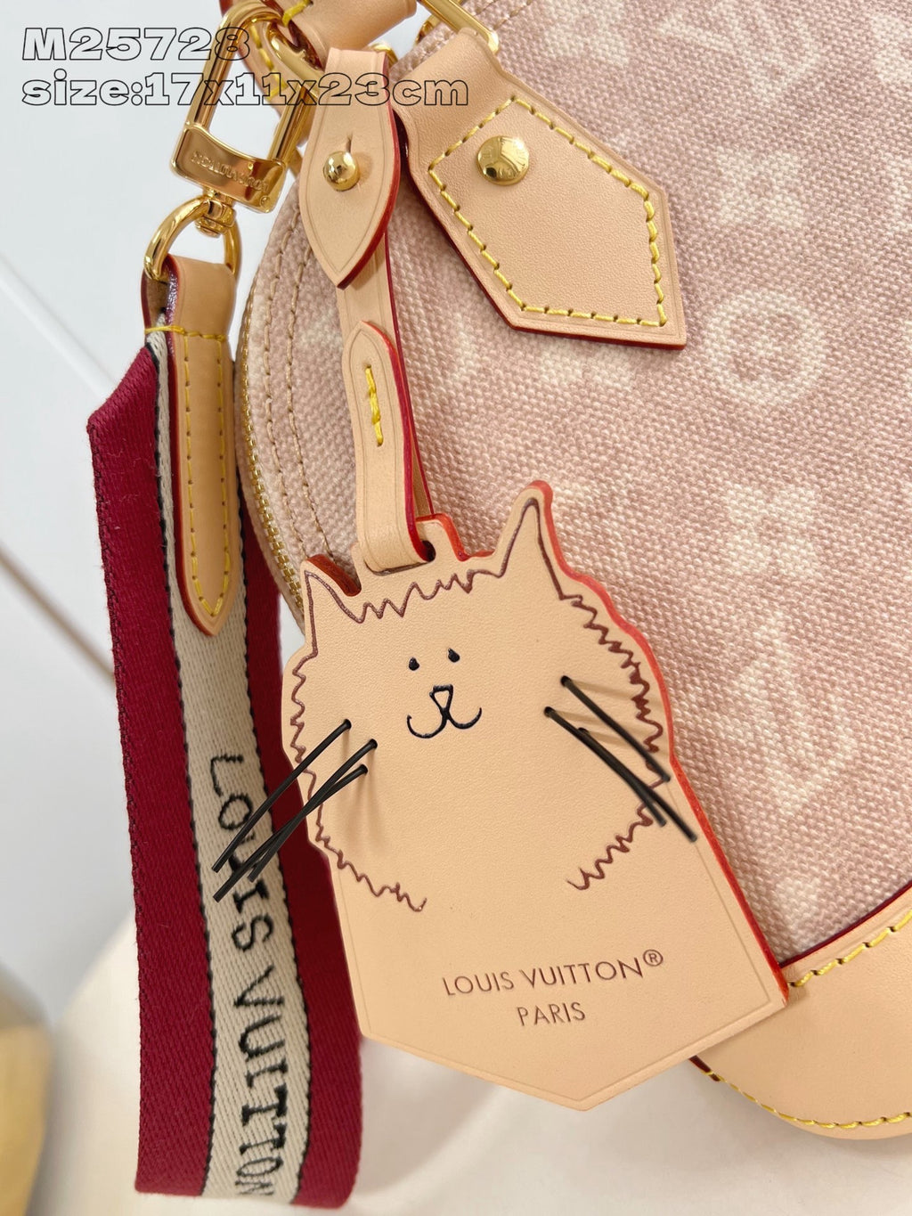Mini monogram bag with cat luggage tag charm, red ribbon strap, gold hardware