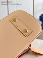 Mini tan bag exterior with rectangular gold-stud patch detail and stitched border